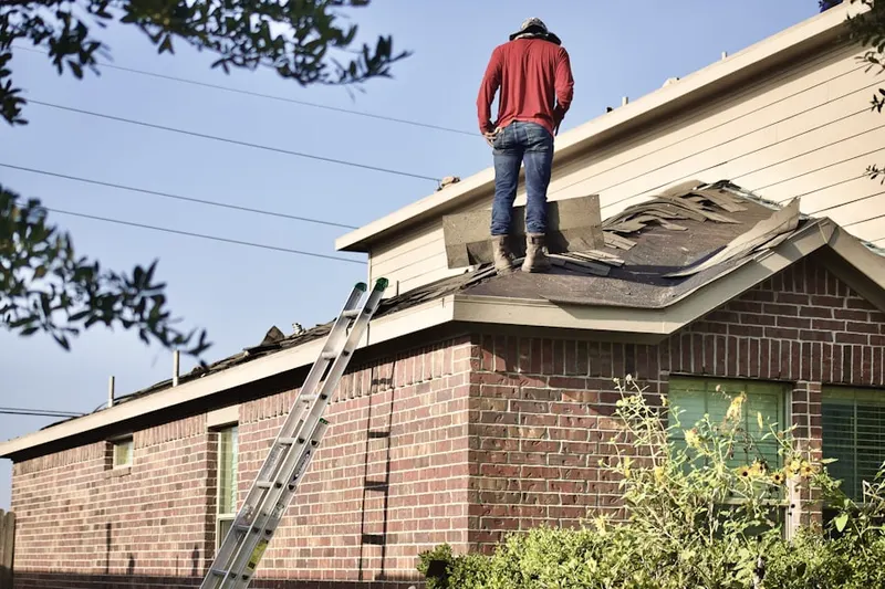 Professional roofer working on a residential roof in Liberty Knolls